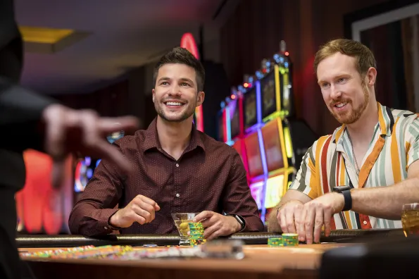 Two young guys playing blackjack at Little River Casino Resort