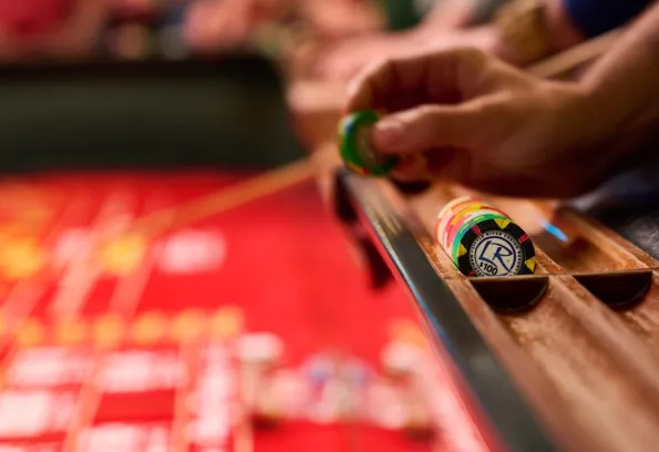 Hand holding casino chip