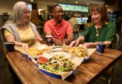A few people eating nachos
