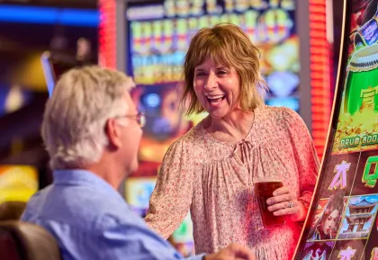 Couple enjoying slot machines
