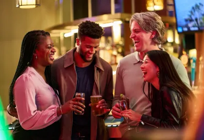 People laughing while enjoying drinks
