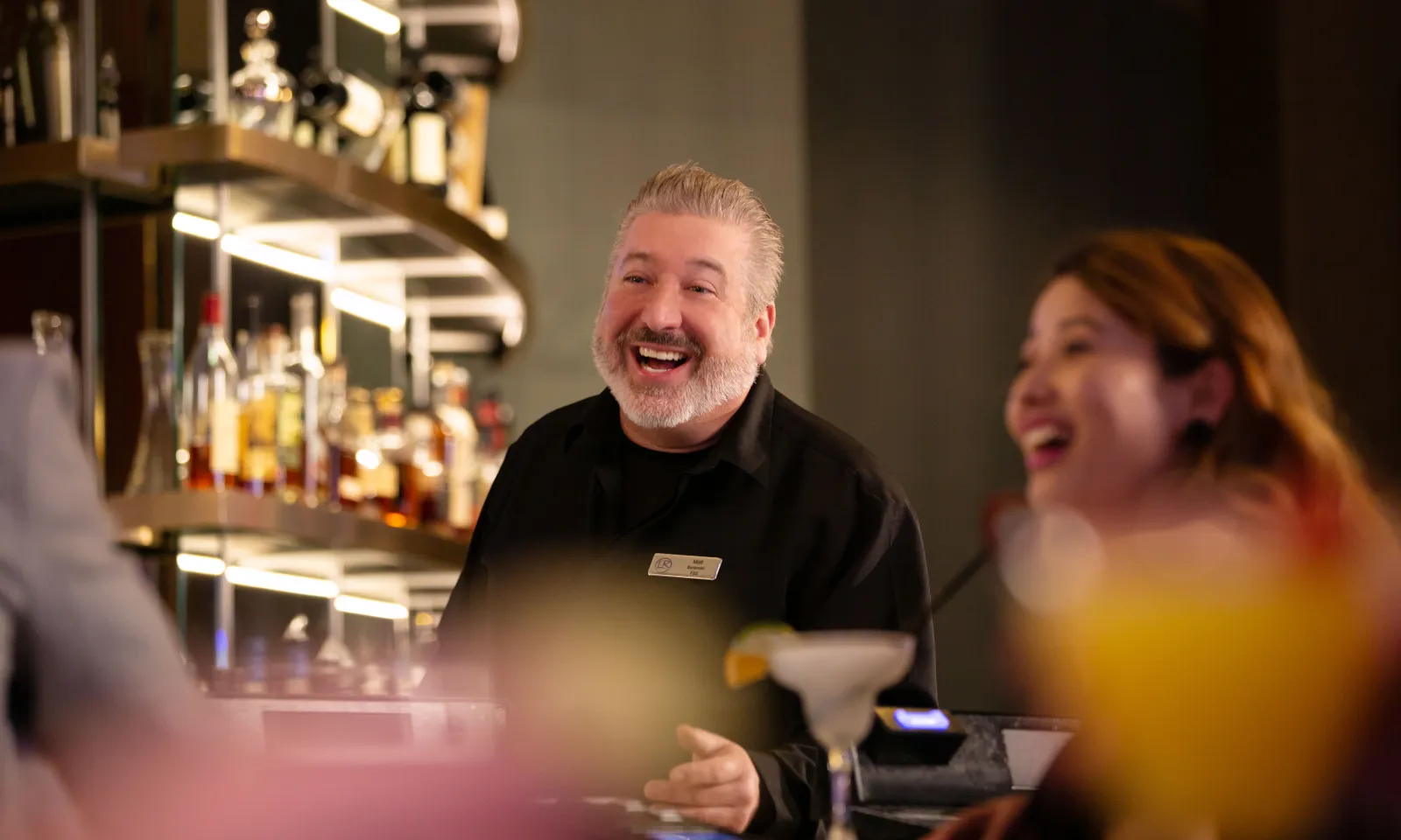 A happy bartender and guest at The Bar in Little River Casino Resort