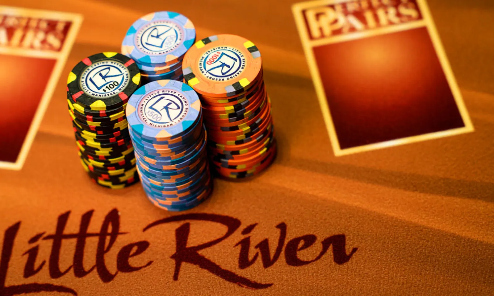 Four stacks of poker chips displayed on a Little River Table 