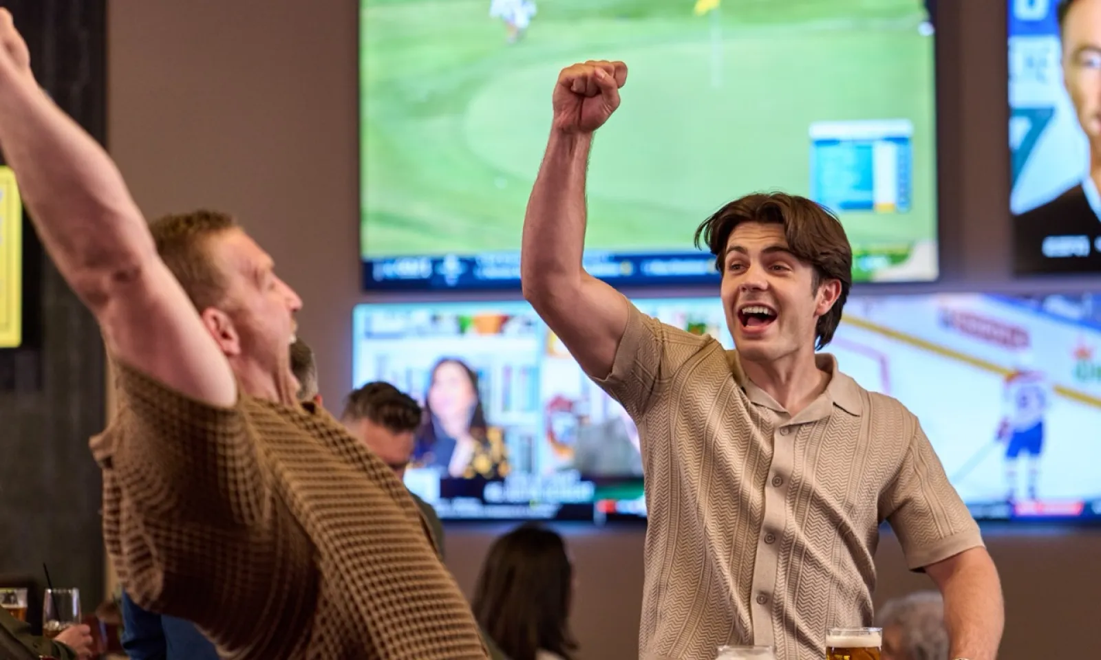 Two men cheering at Sportsbook